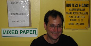 Larry gets his recycling stickers installed at Carrolls